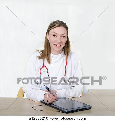 Female doctor using tablet pc View Large Photo Image Stock Image - Female doctor using tablet pc. Fotosearch