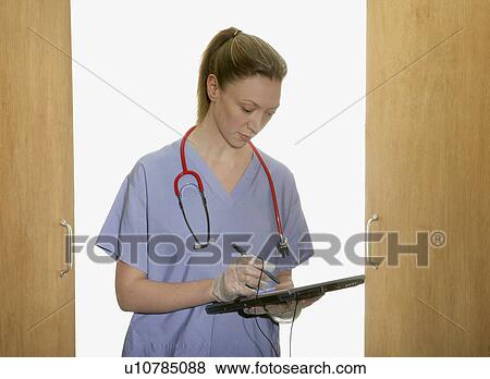 Female doctor using tablet pc View Large Photo Image Stock Photo - Female doctor using tablet pc. Fotosearch