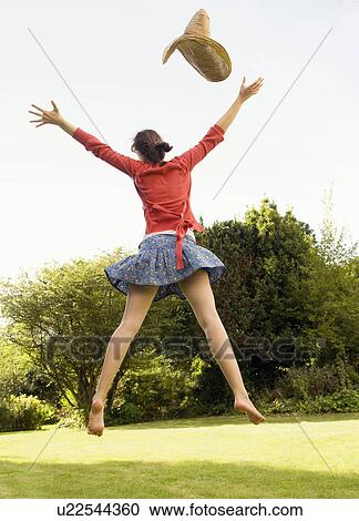 Stock Image - Female jumping in the air.. Fotosearch