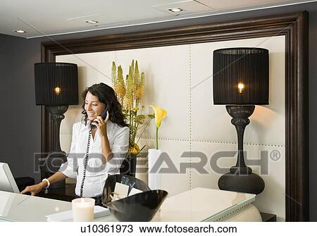 Female receptionist talking on the phone View Large Photo Image Stock Image - Female receptionist talking on the phone. Fotosearch