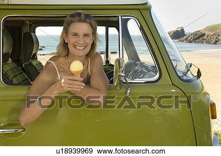 Female sat in camper van with ice cream View Large Photo Image Stock Photo - Female sat in camper van with ice cream. Fotosearch