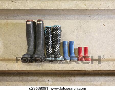 Stock Image - Four Pairs Of Wellington Boots. Fotosearch