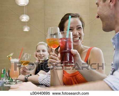 Stock Photography - Friends drinking together. Fotosearch
