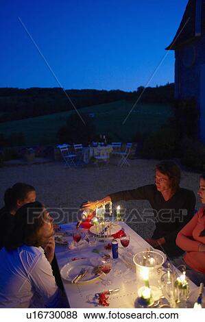 Friends having dinner outside View Large Photo Image Stock Photo - Friends having dinner outside. Fotosearch