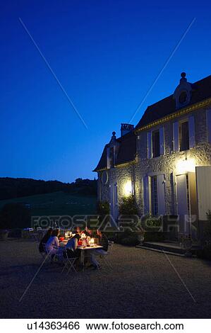 Stock Photograph - Friends having dinner outside. Fotosearch