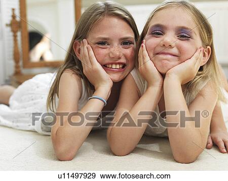 Stock Photo - Friends showing make-up experiments. Fotosearch