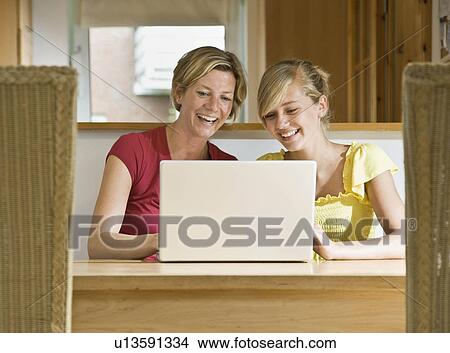 Girl and woman working on computer View Large Photo Image Picture - Girl and woman working on computer. Fotosearch