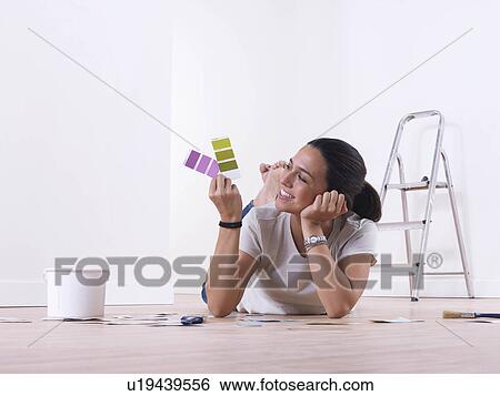 Stock Photograph - Girl choosing paint colours. Fotosearch