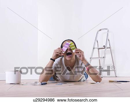 Stock Photograph - Girl choosing paint colours. Fotosearch