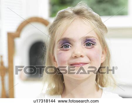 Picture - Girl having done her own make-up. Fotosearch