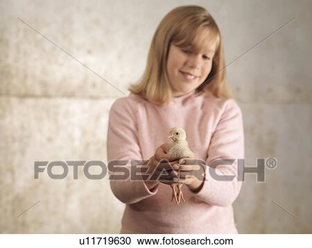Stock Image - Girl Holding Chick. Fotosearch