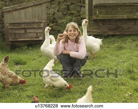 Girl Holding Egg With Hens And Geese View Large Photo Image Stock Photo - Girl Holding Egg With Hens And Geese. Fotosearch