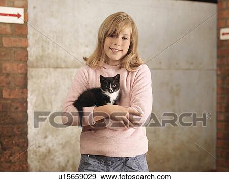 Stock Photo - Girl Holding Kitten. Fotosearch