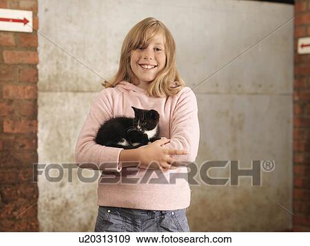 Stock Photo - Girl Holding Kitten. Fotosearch