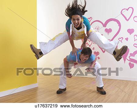 Girl leap frogs over man. View Large Photo Image Stock Photo - Girl leap frogs over man.. Fotosearch