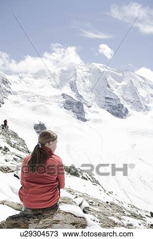 Stock Image - girl looking at mountain scenery. Fotosearch