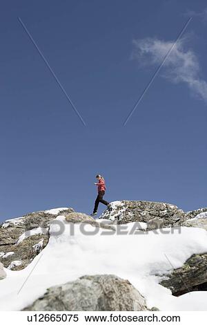 Stock Photography - girl looking at mountain scenery. Fotosearch