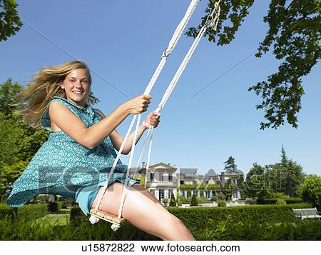 Stock Image - Girl on a swing. Fotosearch