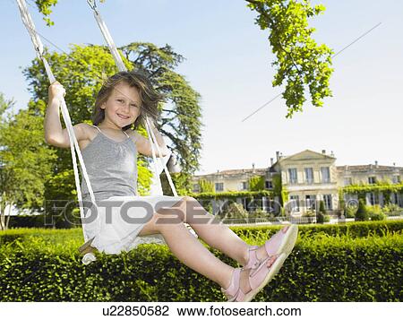 Stock Image - Girl on a swing. Fotosearch