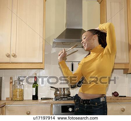 Girl singing in kitchen View Large Photo Image Picture - Girl singing in kitchen. Fotosearch