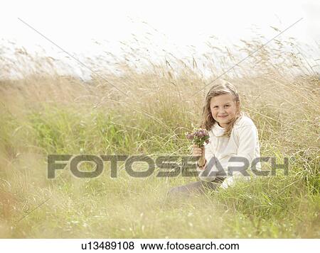 Girl Sitting In Grass With Flowers View Large Photo Image Stock Photo - Girl Sitting In Grass With Flowers. Fotosearch