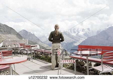 Stock Image - girl using binocular to view mountains. Fotosearch