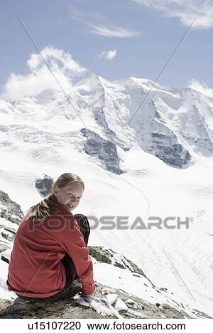 Stock Image - girl walking a path in the mountains. Fotosearch