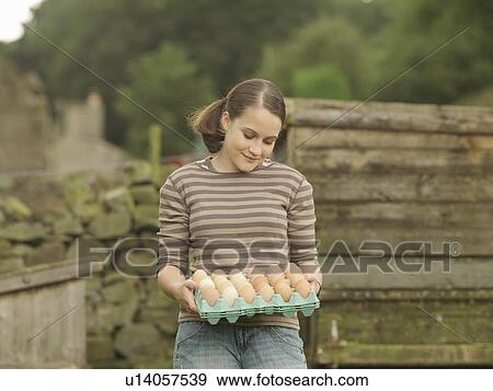 Girl With A Tray Of Eggs View Large Photo Image Stock Photo - Girl With A Tray Of Eggs. Fotosearch