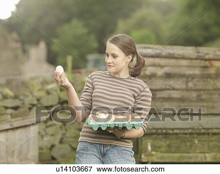 Girl With A Tray Of Eggs View Large Photo Image Stock Photo - Girl With A Tray Of Eggs. Fotosearch