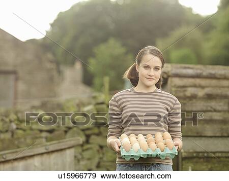 Girl With A Tray Of Eggs View Large Photo Image Stock Photo - Girl With A Tray Of Eggs. Fotosearch