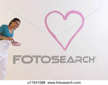 Stock Photo - Girl with heart painting.. Fotosearch
