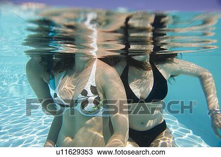 Stock Image - Girls in swimming pool. Fotosearch