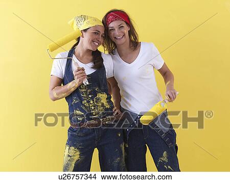 Picture - Girls posing in front of wall.. Fotosearch