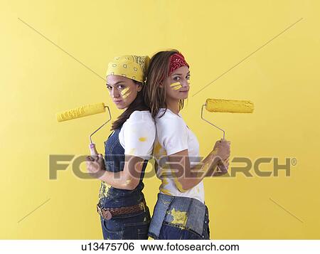 Stock Photograph - Girls posing in front of wall.. Fotosearch