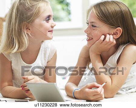 Girls smiling, putting on make-up View Large Photo Image Stock Photo - Girls smiling, putting on make-up. Fotosearch
