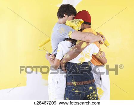 Stock Photo - Group hugging in front of wall.. Fotosearch
