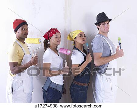 Stock Photo - Group of friends about to paint wall.. Fotosearch