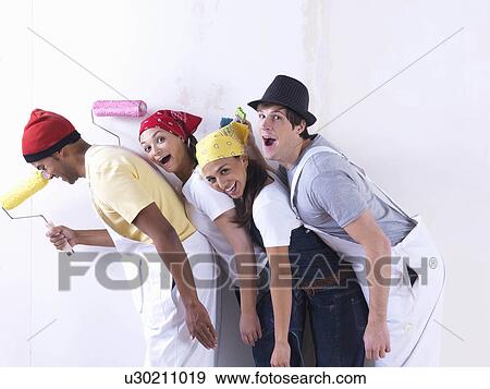 Stock Photo - Group of friends about to paint wall.. Fotosearch