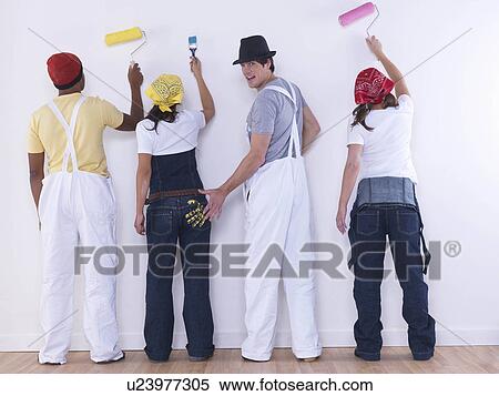 Stock Photography - Group of friends about to paint wall.. Fotosearch
