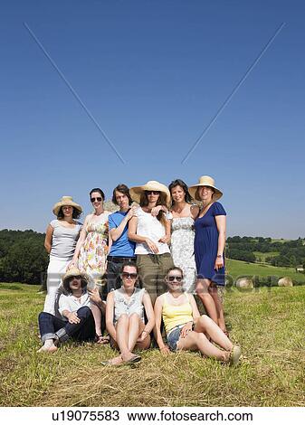 Group of friends in field View Large Photo Image Stock Image - Group of friends in field. Fotosearch