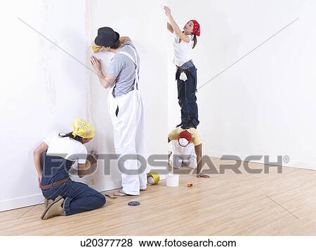 Group of friends sanding wall. View Large Photo Image Stock Photo - Group of friends sanding wall.. Fotosearch