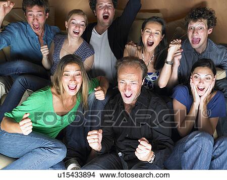 Picture - Group of friends watching television. Fotosearch
