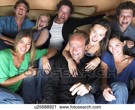 Stock Image - Group of friends watching television. Fotosearch