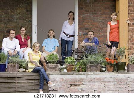 Stock Image - Group portrait of a family on the porch. Fotosearch