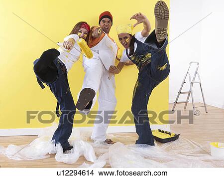 Picture - Group posing in front of wall.. Fotosearch