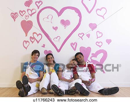 Stock Image - Group sitting under hearts.. Fotosearch