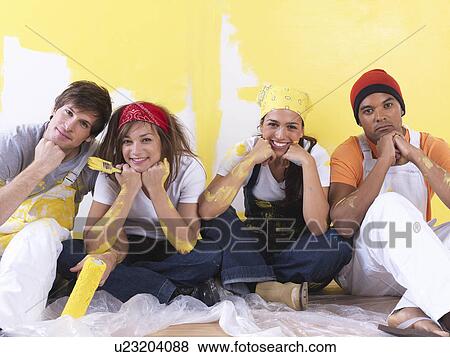 Stock Photo - Group taking a break from painting.. Fotosearch