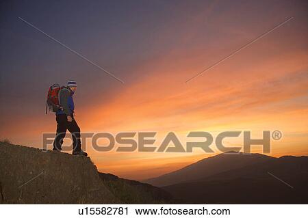Hiker looking at the sunrise. View Large Photo Image Stock Image - Hiker looking at the sunrise.. Fotosearch