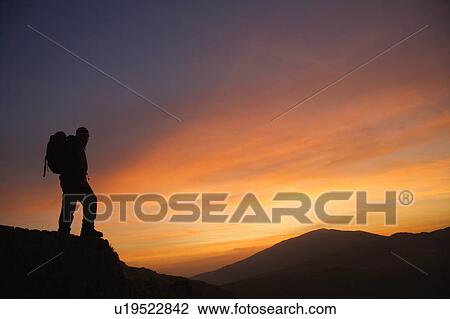 Hiker looking at the sunrise. View Large Photo Image Stock Image - Hiker looking at the sunrise.. Fotosearch