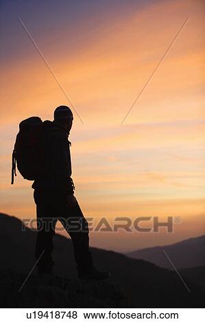 Hiker looking at the sunrise. View Large Photo Image Stock Photo - Hiker looking at the sunrise.. Fotosearch